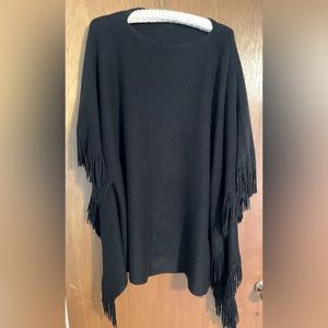 Black women’s large pullover poncho/sweater with fringe.